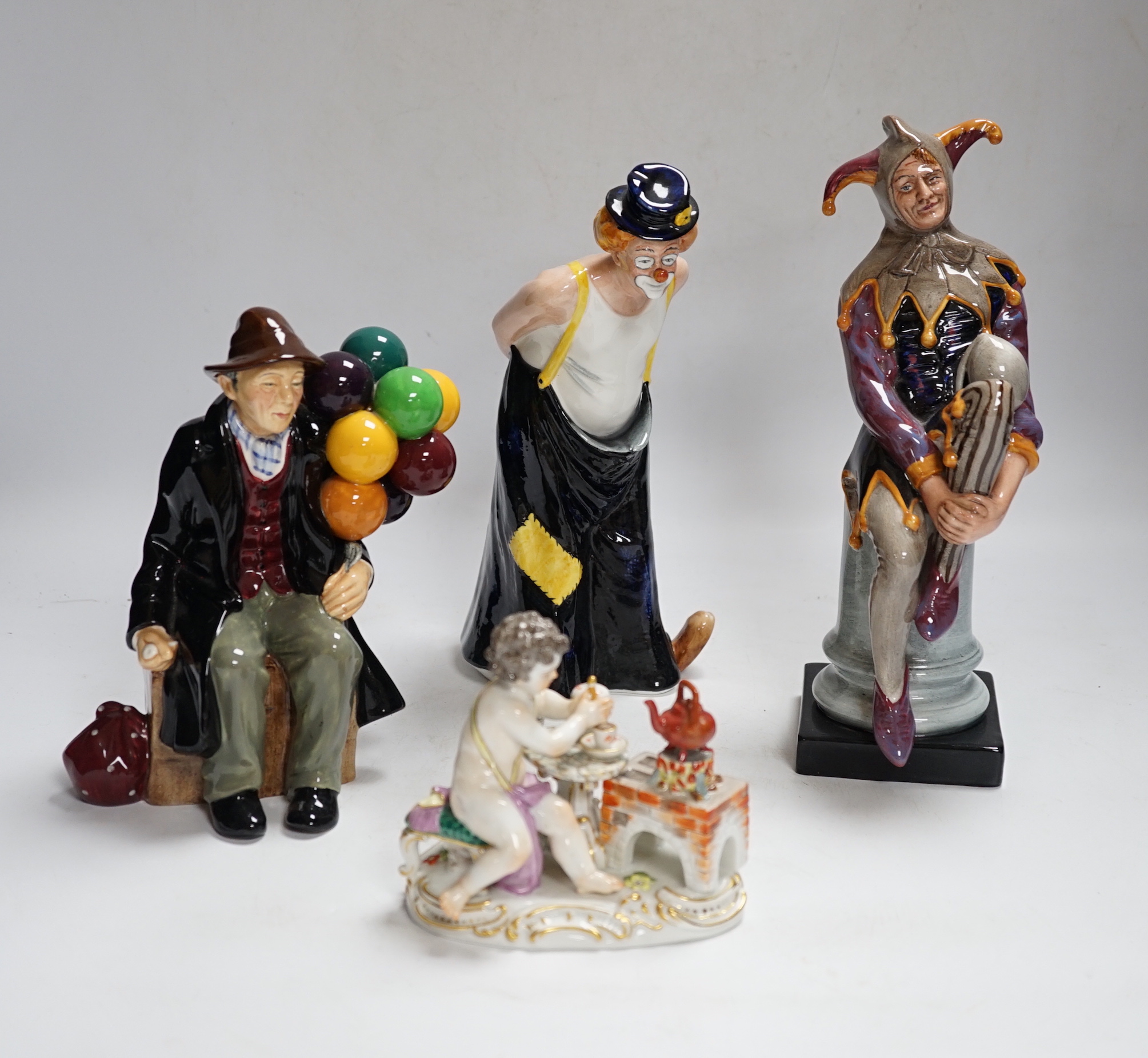 Four Royal Doulton character figures, a Royal Crown Derby Koi Carp paper weight, a continental putti group, a Coalport figure, a glass model of a golfer and three mixed metal and ceramic figures (11)